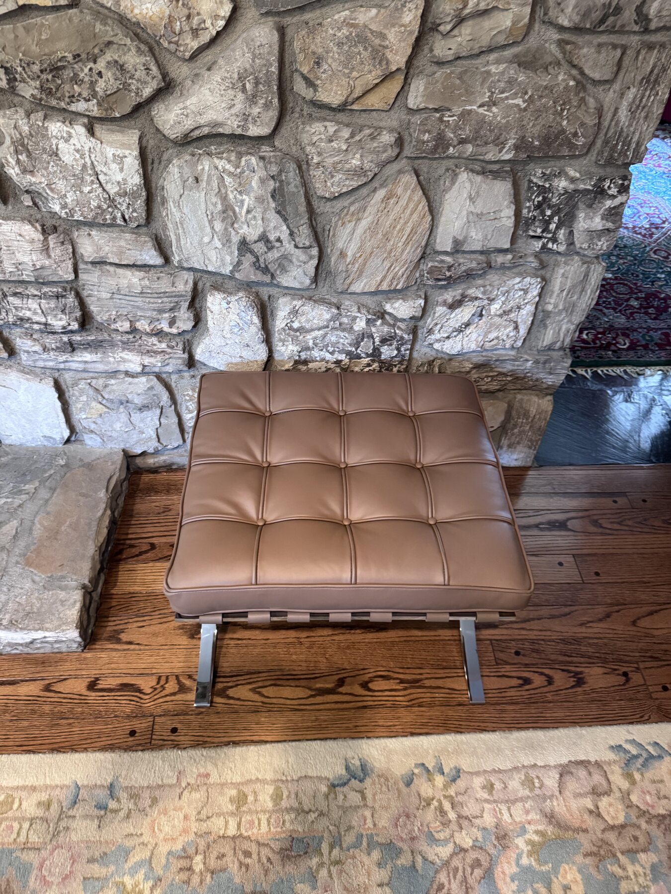 After restoration in-home view of the Barcelona ottoman with darker room lighting